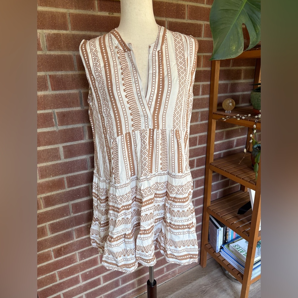 Boho tunic dress features a brown and white geometric pattern with tiered skirt